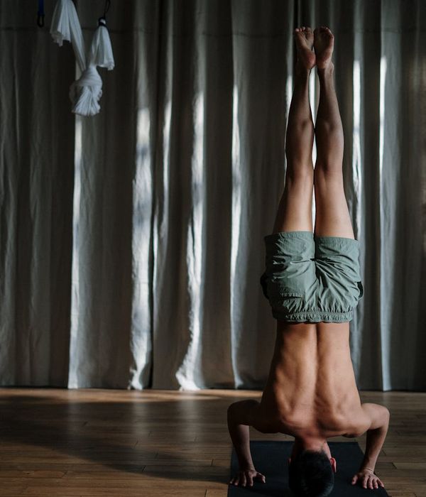 Man in a focused pose showing balance and core strength.